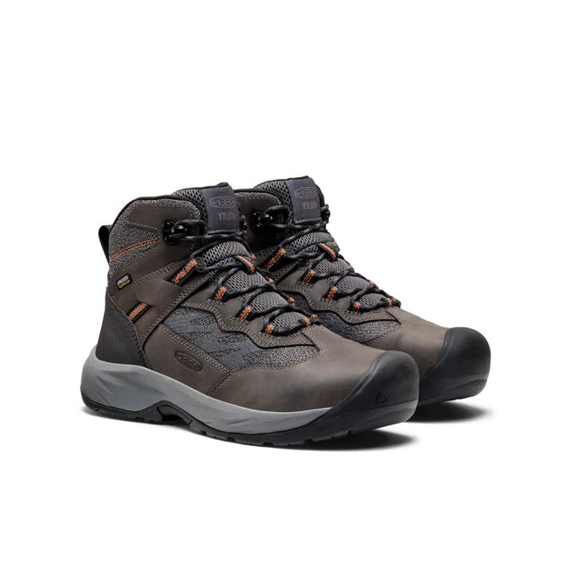 Pair of gray hiking boots with orange accents on a white background