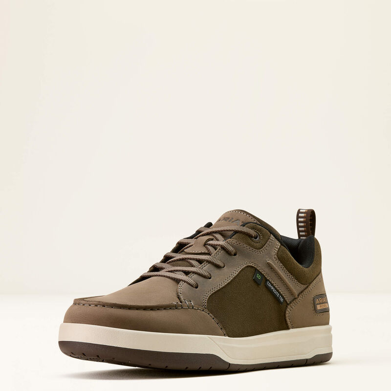 Brown sneaker with a white sole on a light beige background
