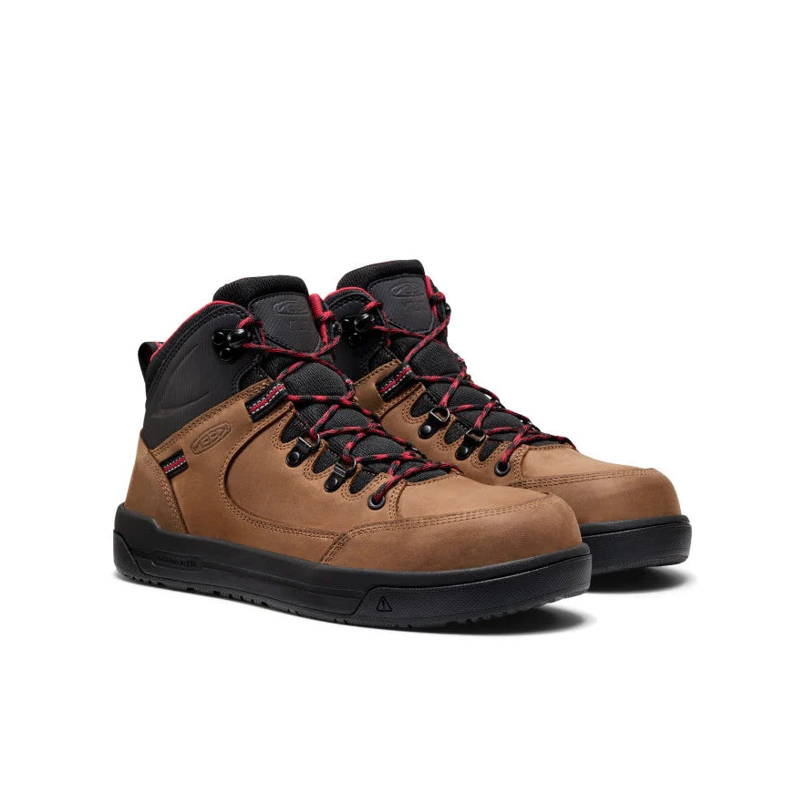 Pair of brown hiking boots with black and red laces on a white background